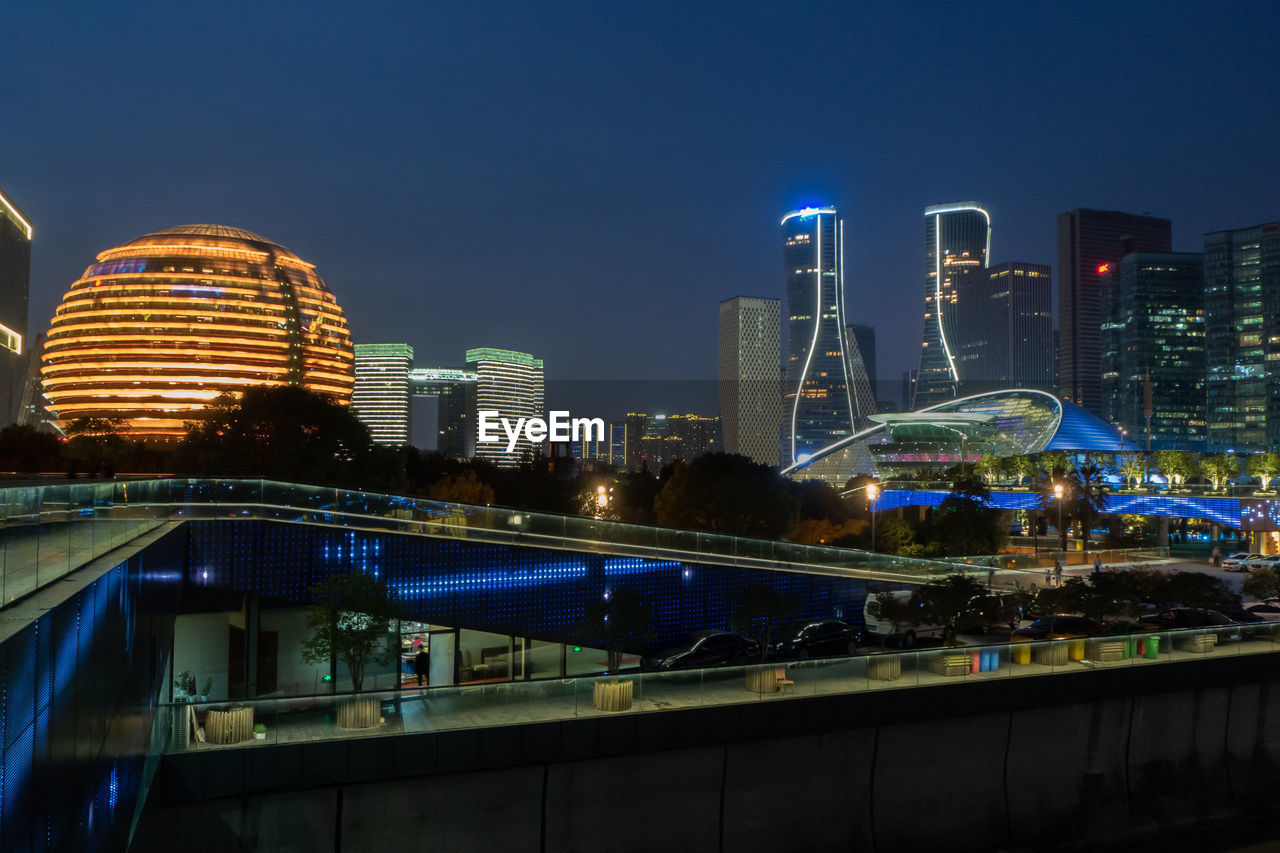 Illuminated modern buildings in city at night