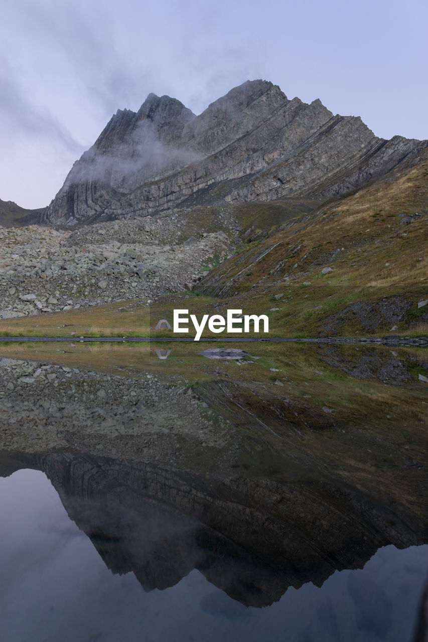 Scenic view of lake and mountains against sky