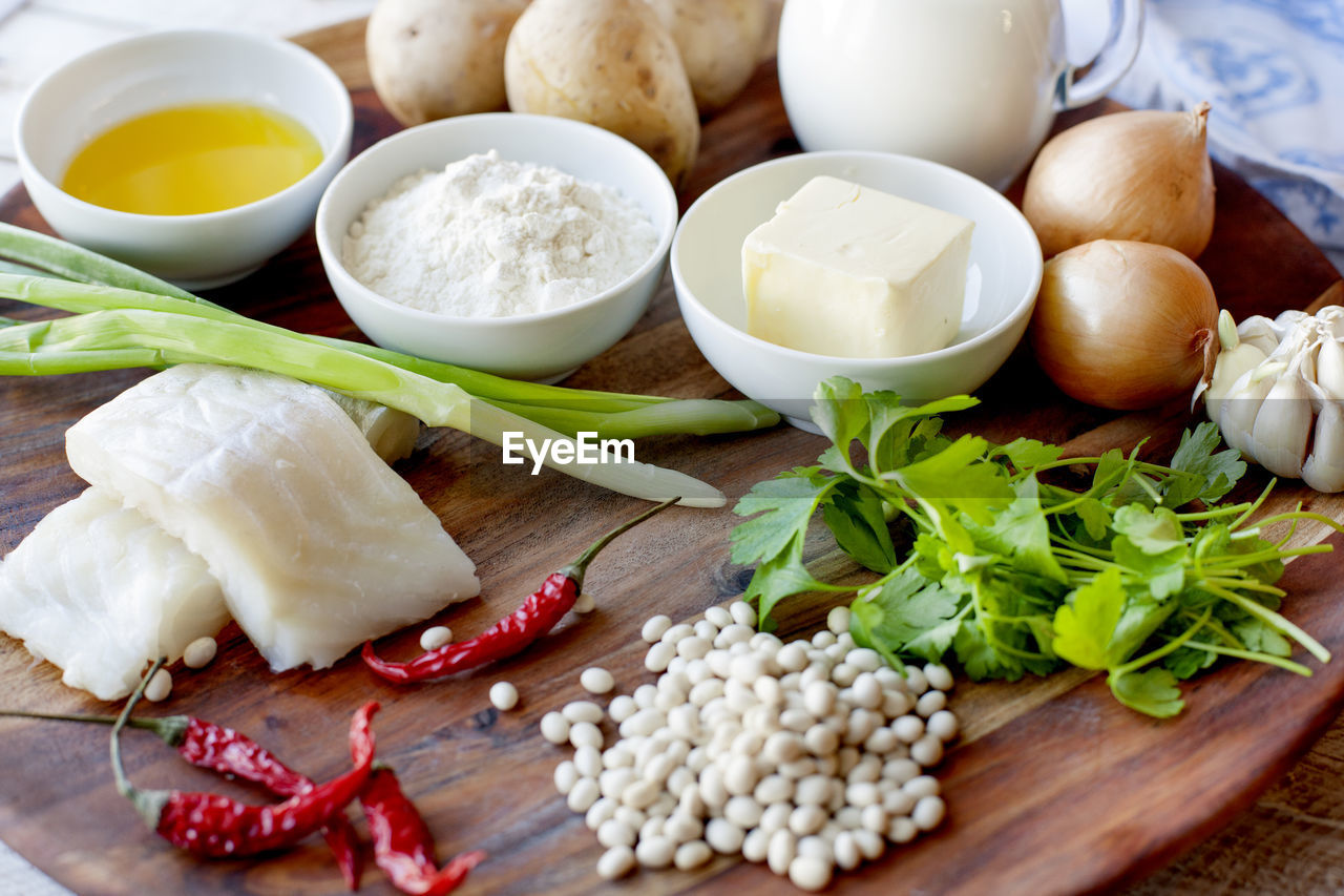 food and drink, food, healthy eating, ingredient, freshness, wellbeing, spice, vegetable, garlic, wood, herb, indoors, dairy, bowl, dish, cutting board, no people, breakfast, cheese, condiment, produce, studio shot, variation, still life, raw food, meal, plant, egg, table, high angle view, onion