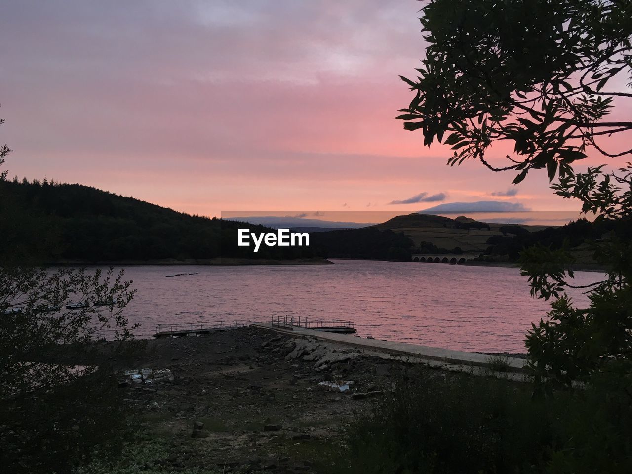 SCENIC VIEW OF LAKE AT SUNSET