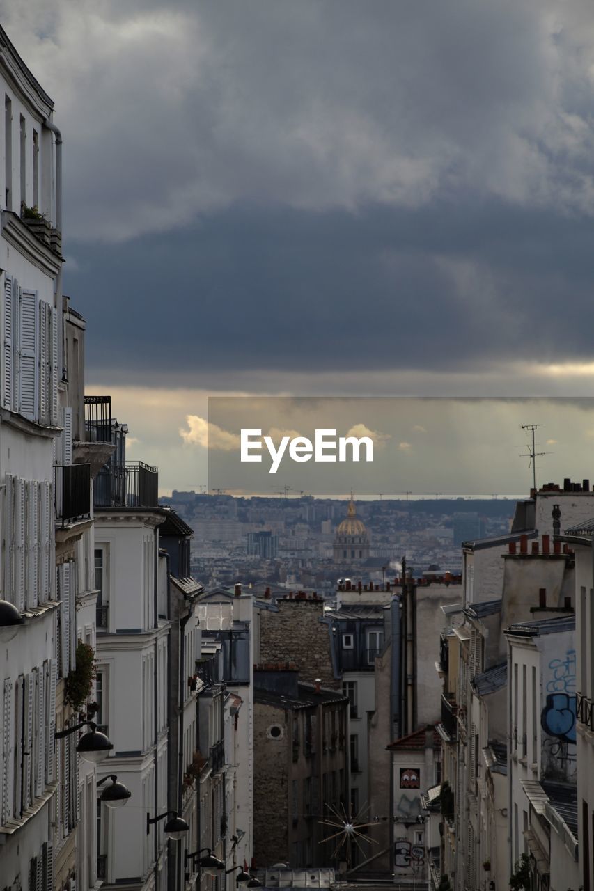 High angle view of buildings against cloudy sky