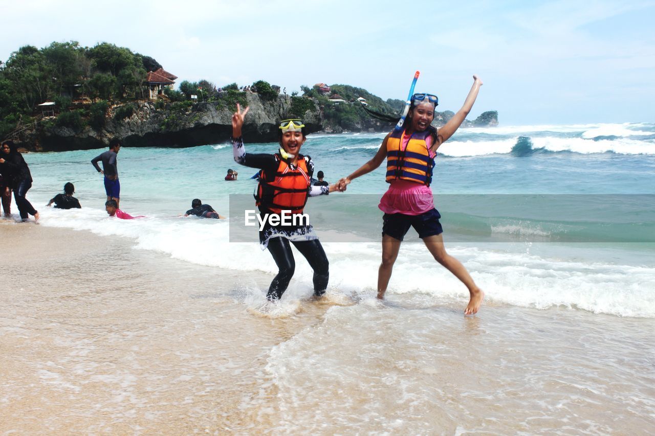 PEOPLE ENJOYING AT BEACH