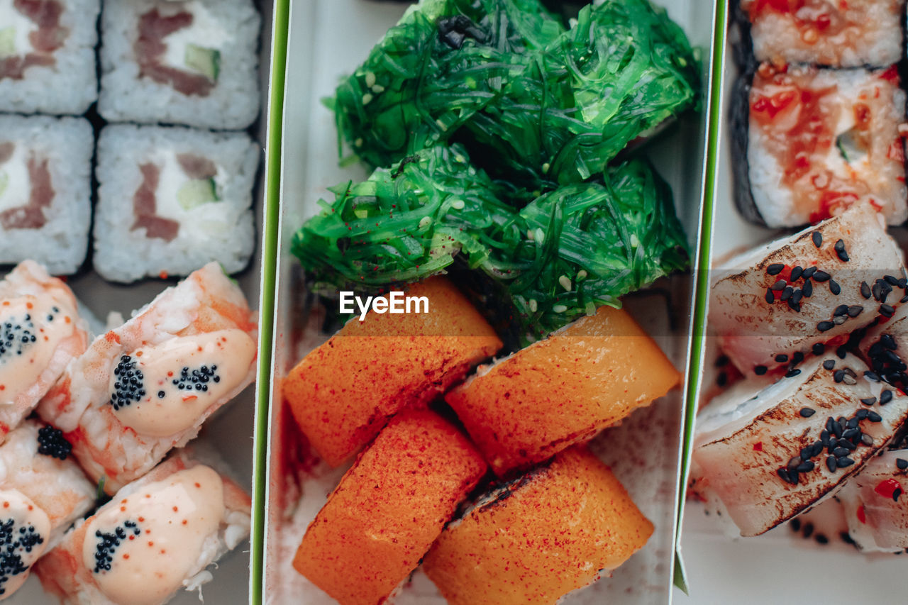 food and drink, food, freshness, healthy eating, cuisine, dish, meal, wellbeing, seafood, japanese food, no people, asian food, japanese cuisine, high angle view, variation, still life, sushi, indoors, california roll, fast food, directly above, close-up, vegetable, culture, salmon, appetizer, large group of objects, serving size, rice, raw food