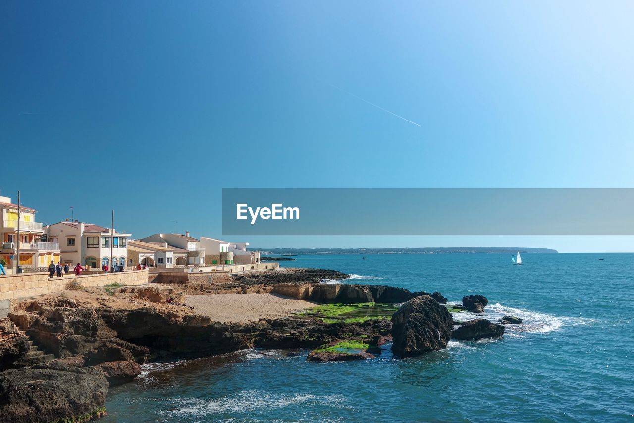 Scenic view of sea against clear blue sky