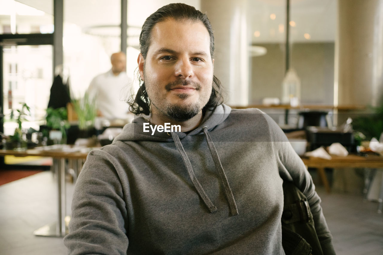 Portrait of smiling man sitting indoors