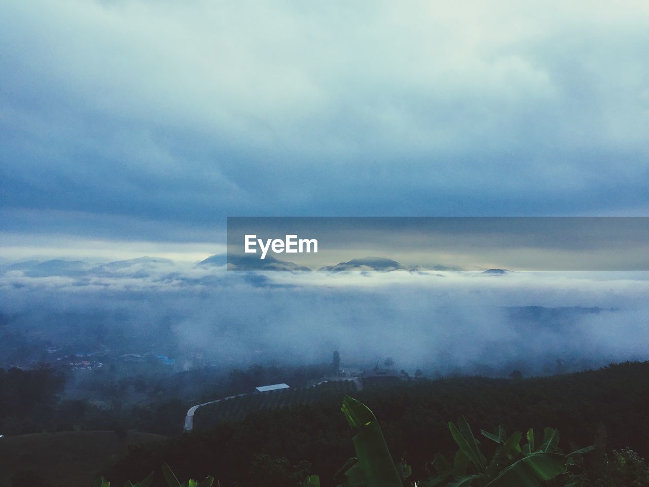 Aerial view of landscape against cloudy sky