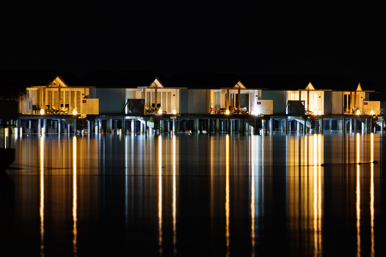 Illuminated building against sky at night