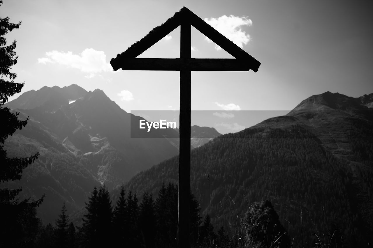 VIEW OF CROSS ON MOUNTAIN AGAINST SKY