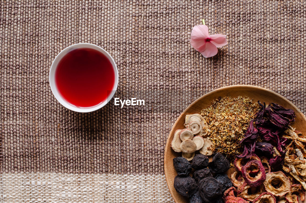 High angle view of potpourri with bowl of aromatic oil on mat