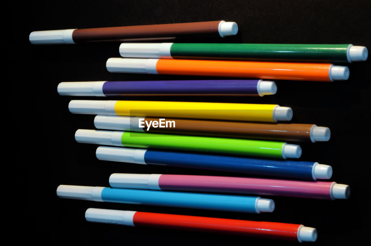 Directly above shot of felt tip pens on black background