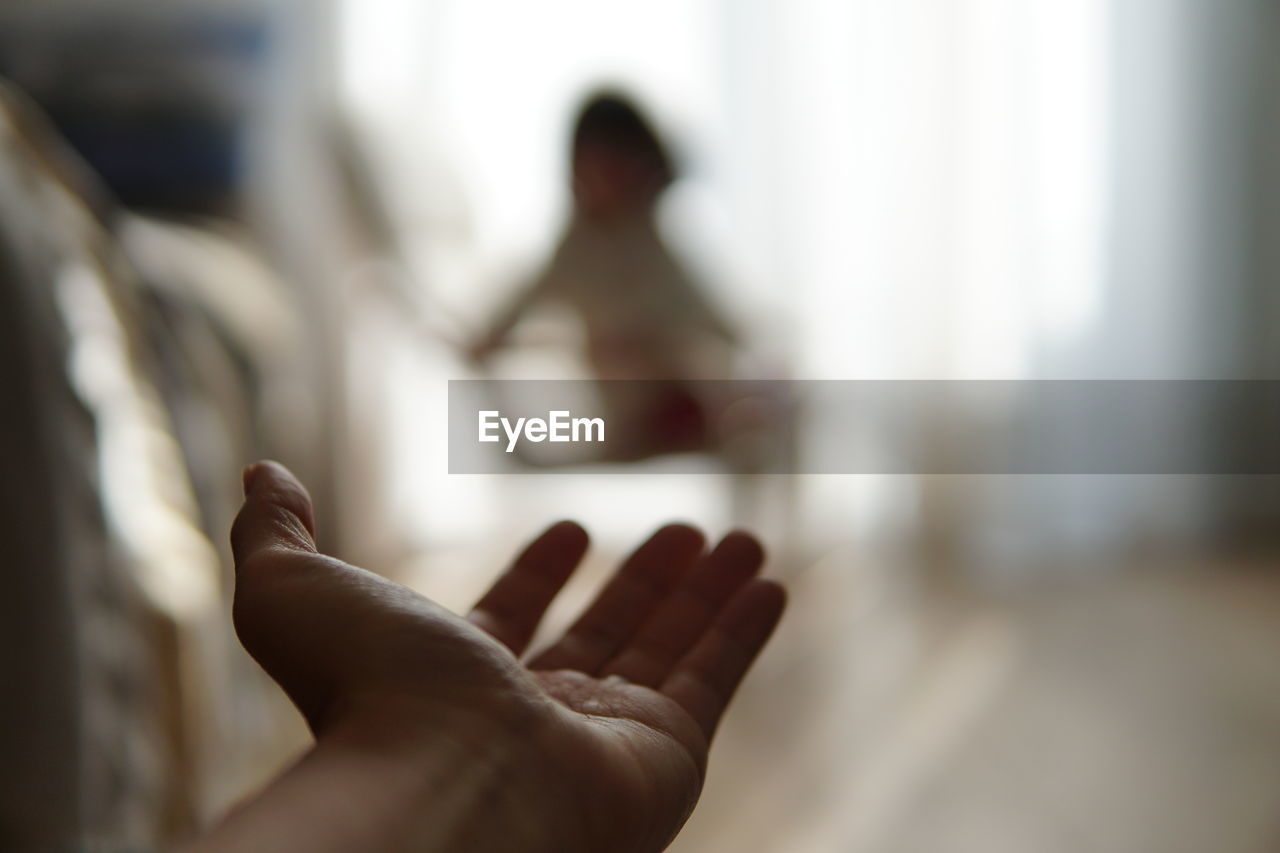 Cropped hand of person gesturing at home