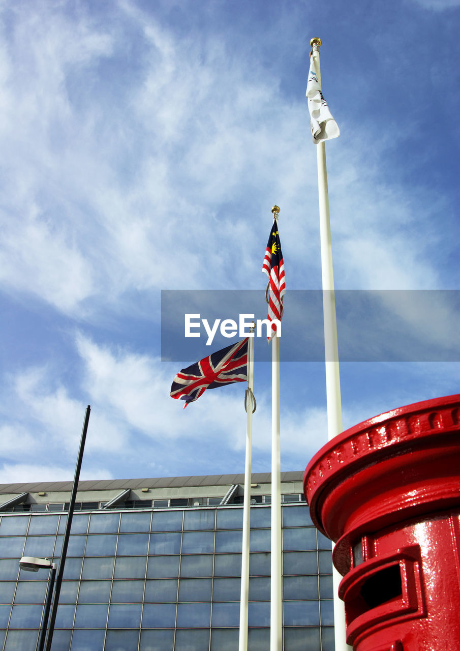 National flags on pole at office building area