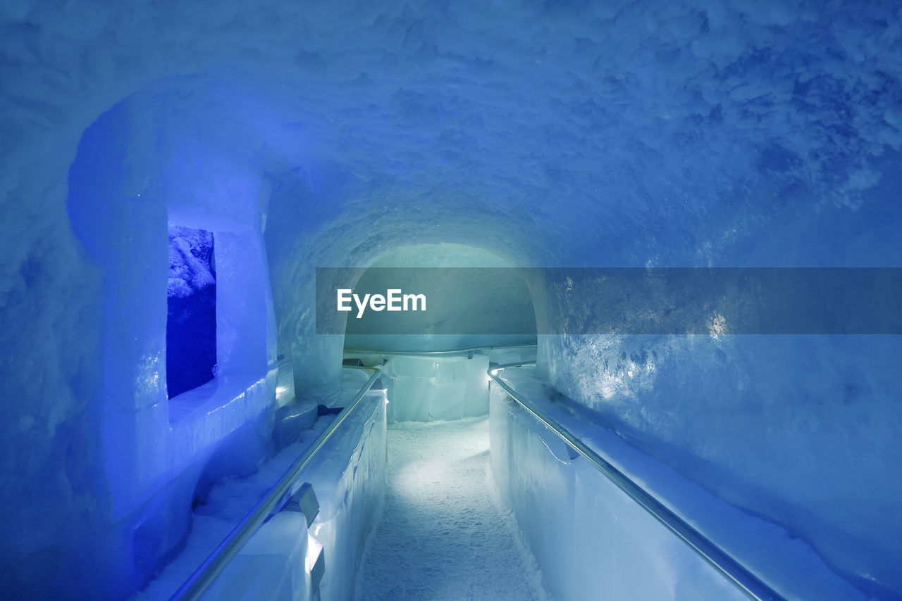 cave, ice hotel, ice cave, tunnel, blue, architecture, ice, indoors, arch, cold temperature, no people, built structure, nature, illuminated, the way forward