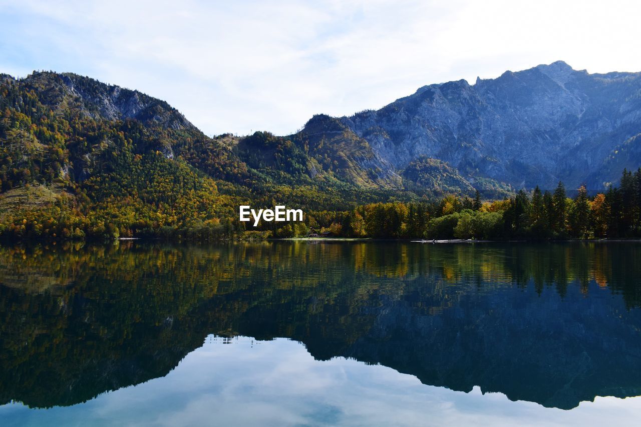 Scenic view of lake and mountains against sky