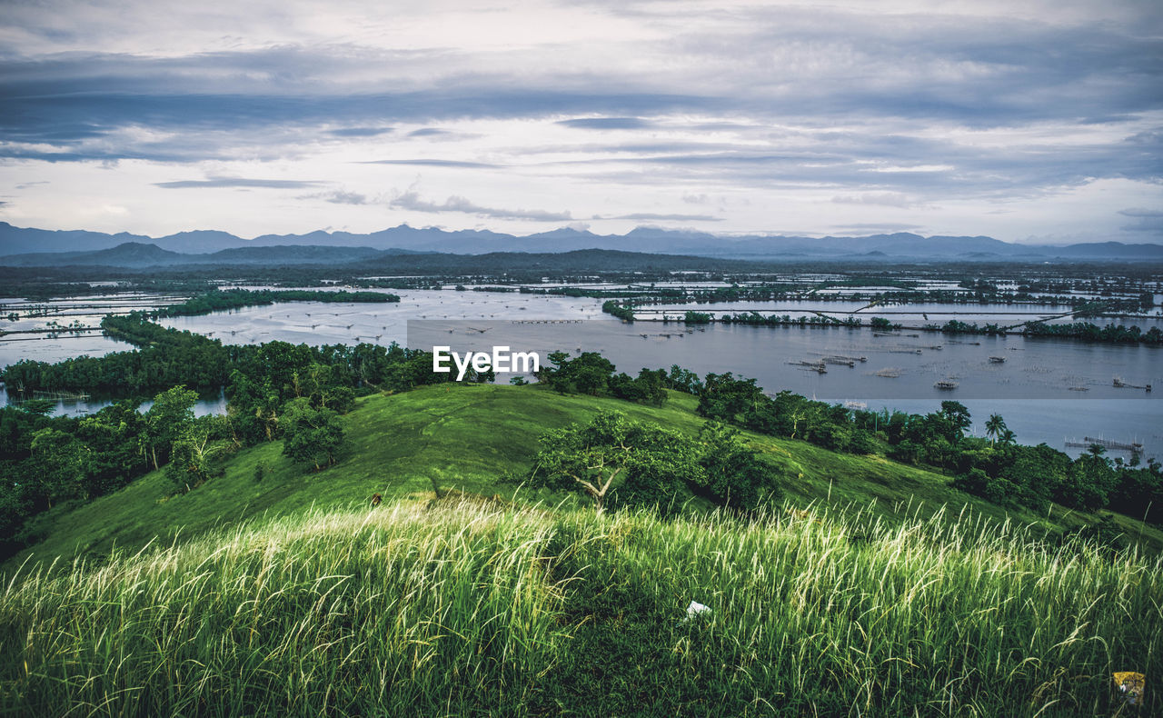 Scenic view of land and sea against sky