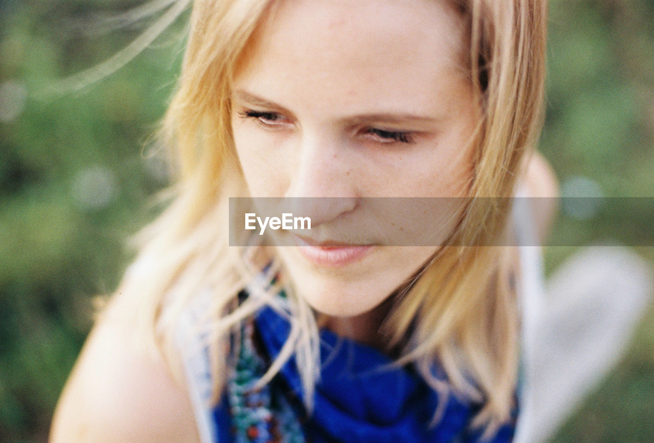 Close-up of thoughtful young woman in park