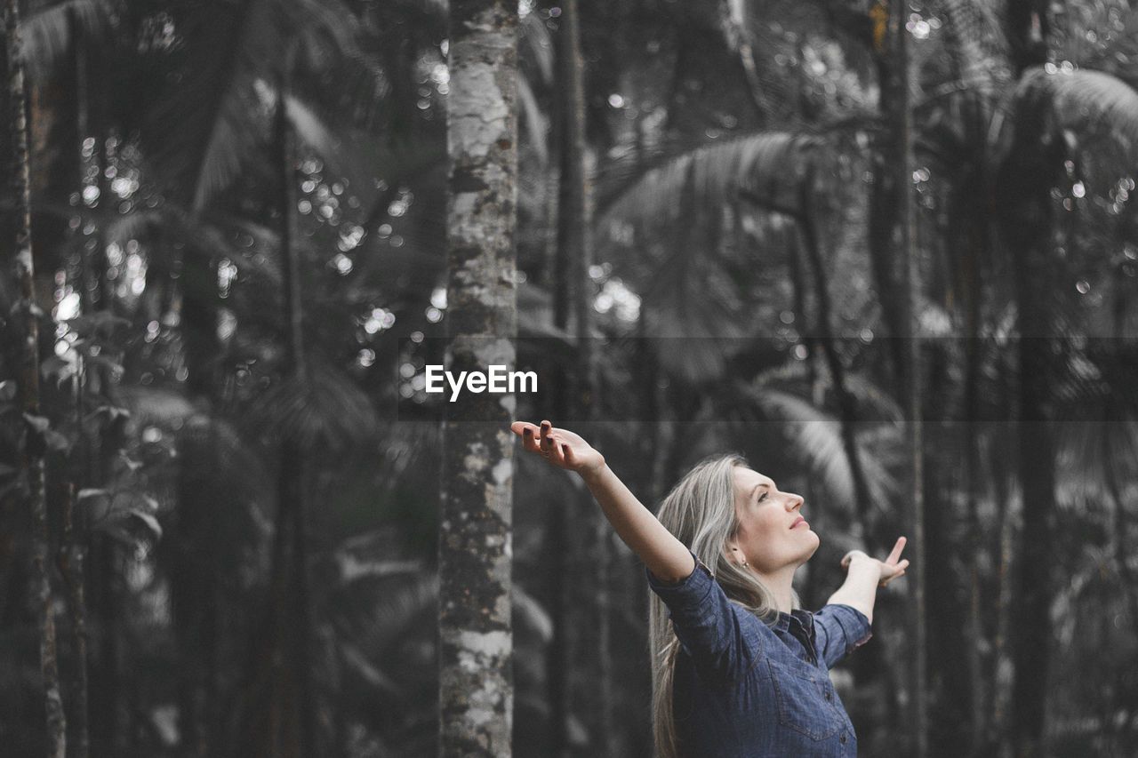 Woman standing in forest