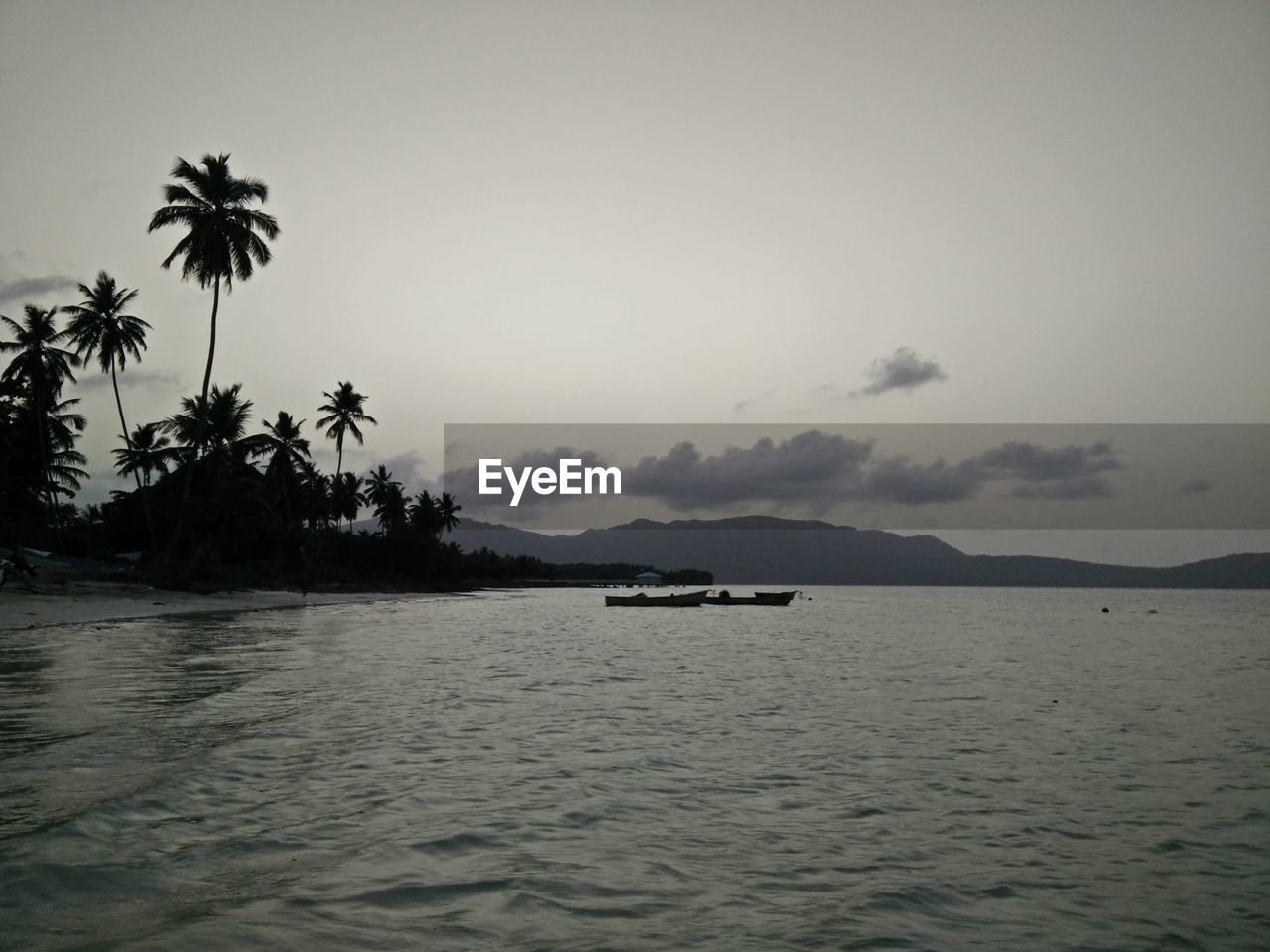 Scenic view of river against sky at dusk