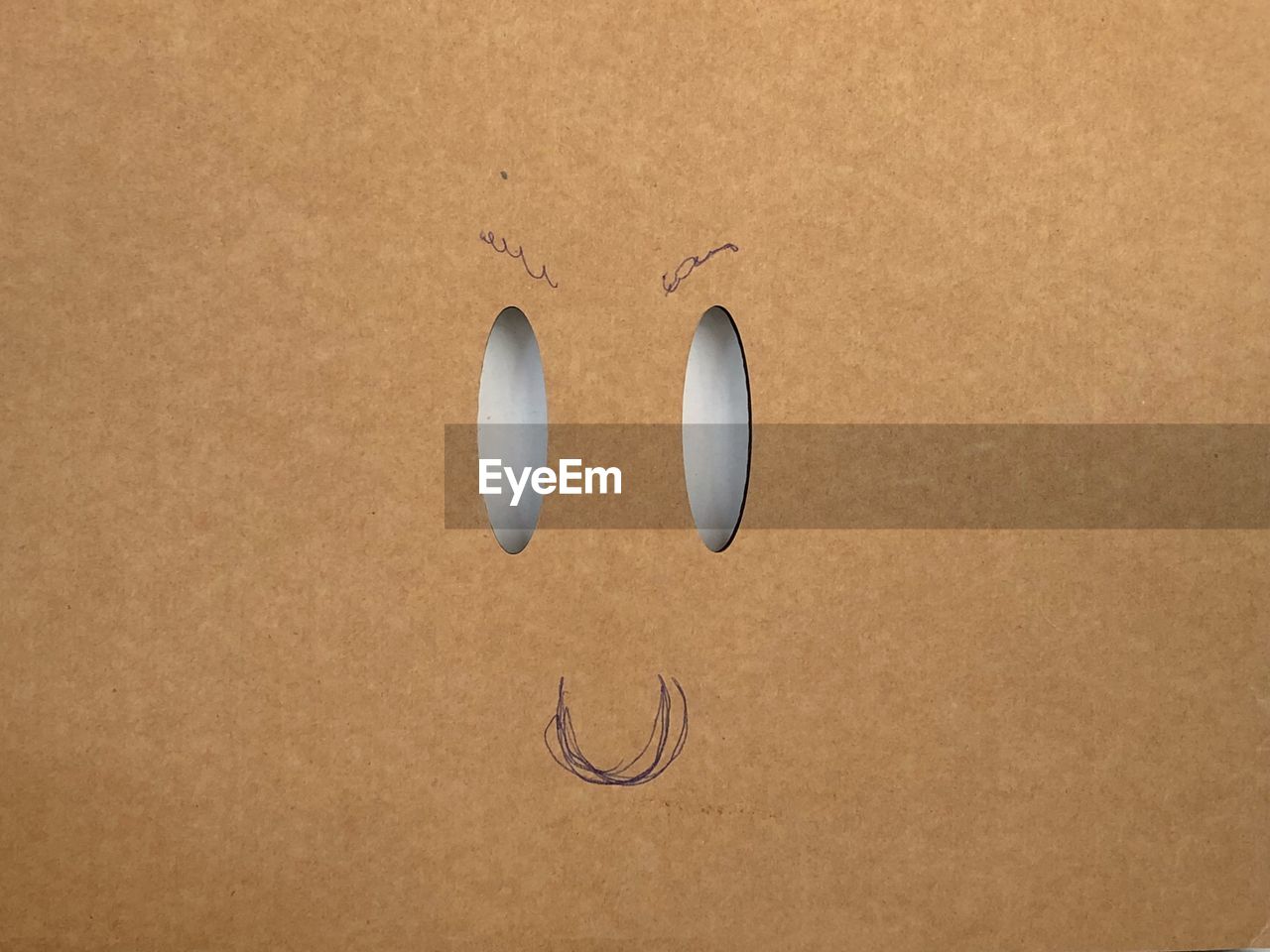 Anthropomorphic face on cardboard