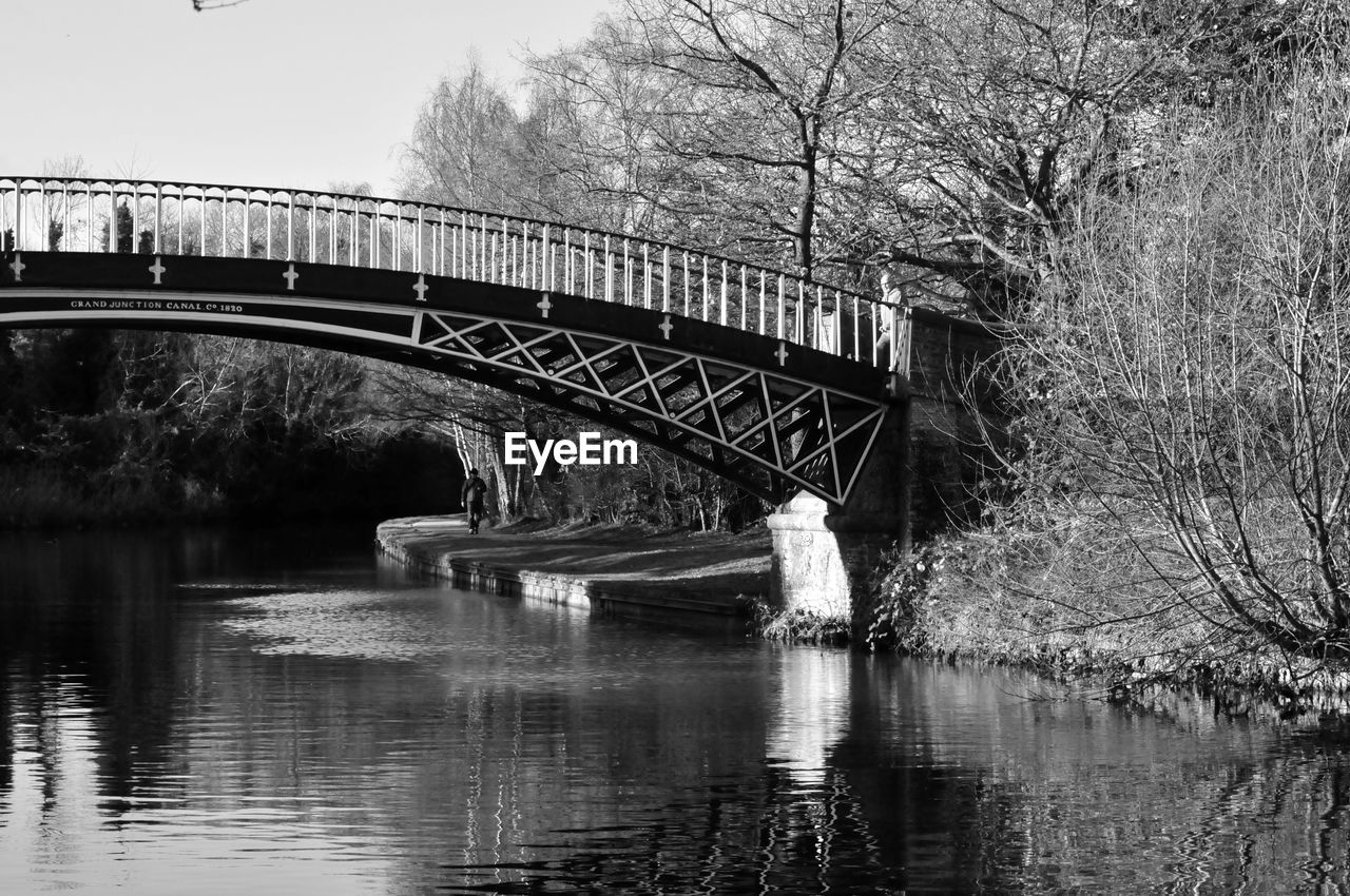 Arch bridge over river against sky