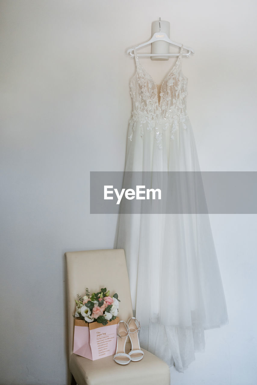 Wedding dress hanging on a lamp