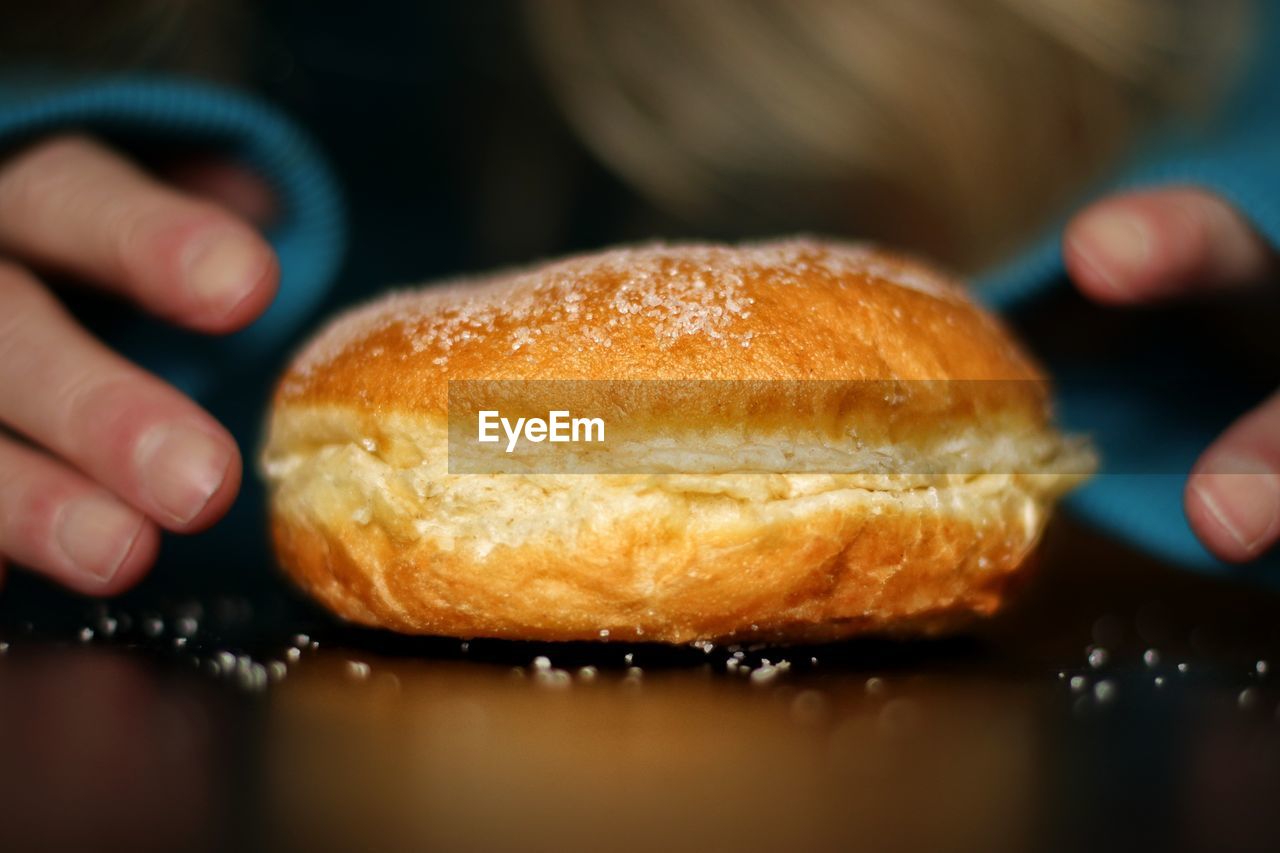 Close-up of hand holding donut