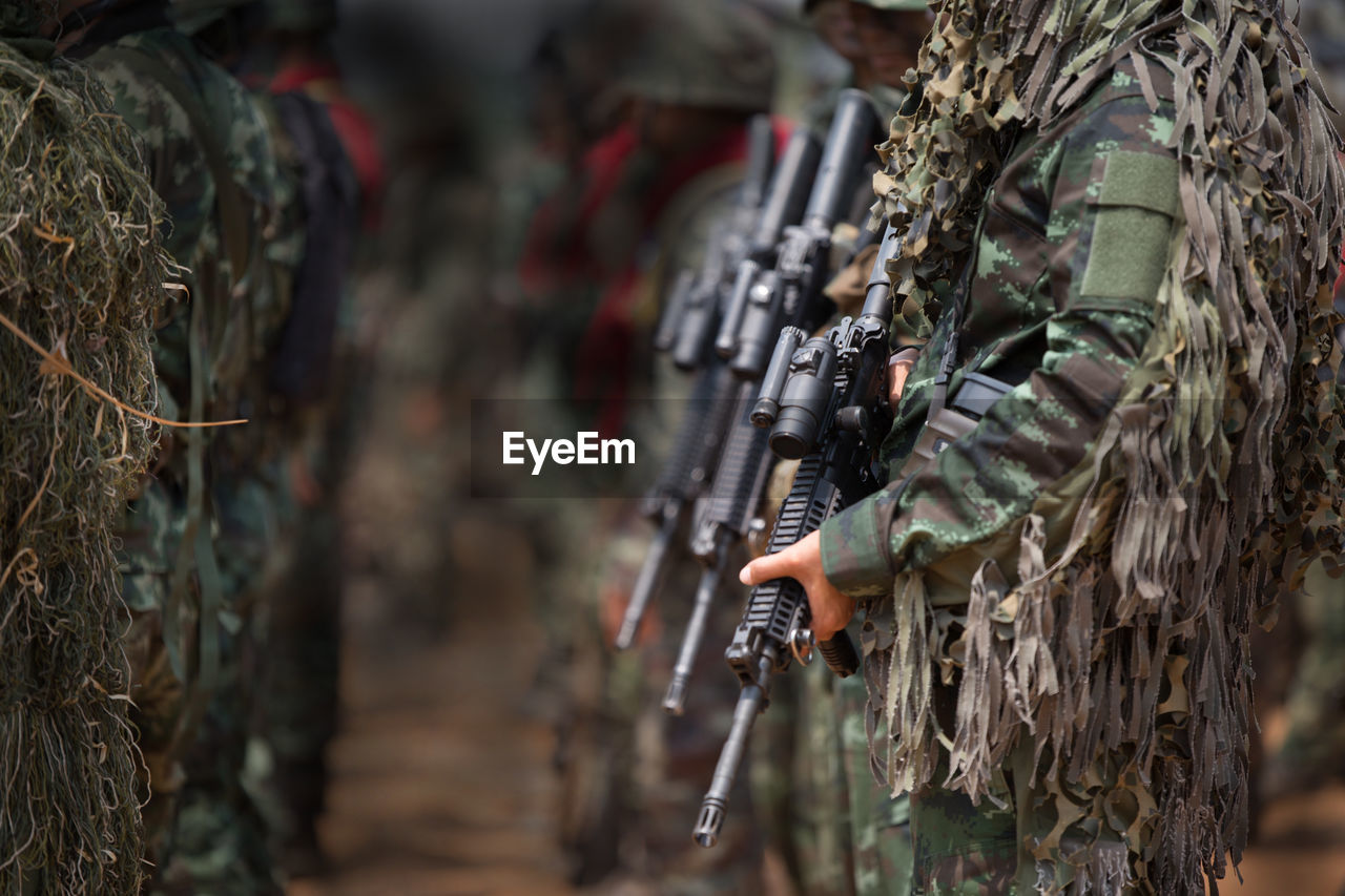 Soldiers with weapons on military combat training