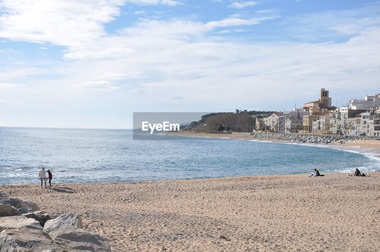 Scenic view of sea by city against sky