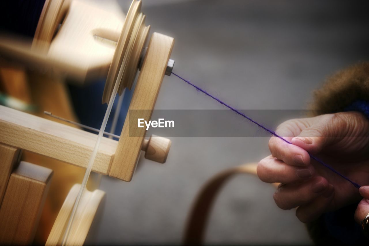 Cropped image of hand holding wool in factory