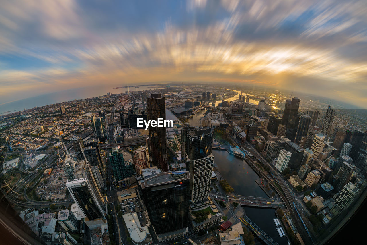 Aerial view of illuminated cityscape against sky at dusk