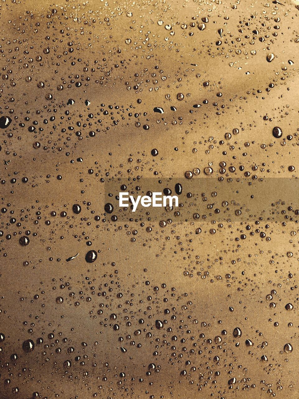 High angle view of raindrops on table