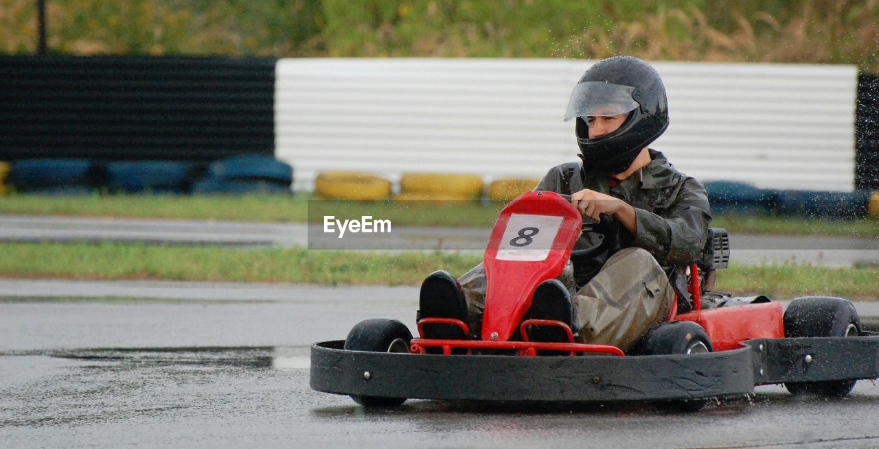 Man driving racecar on wet motor racing track