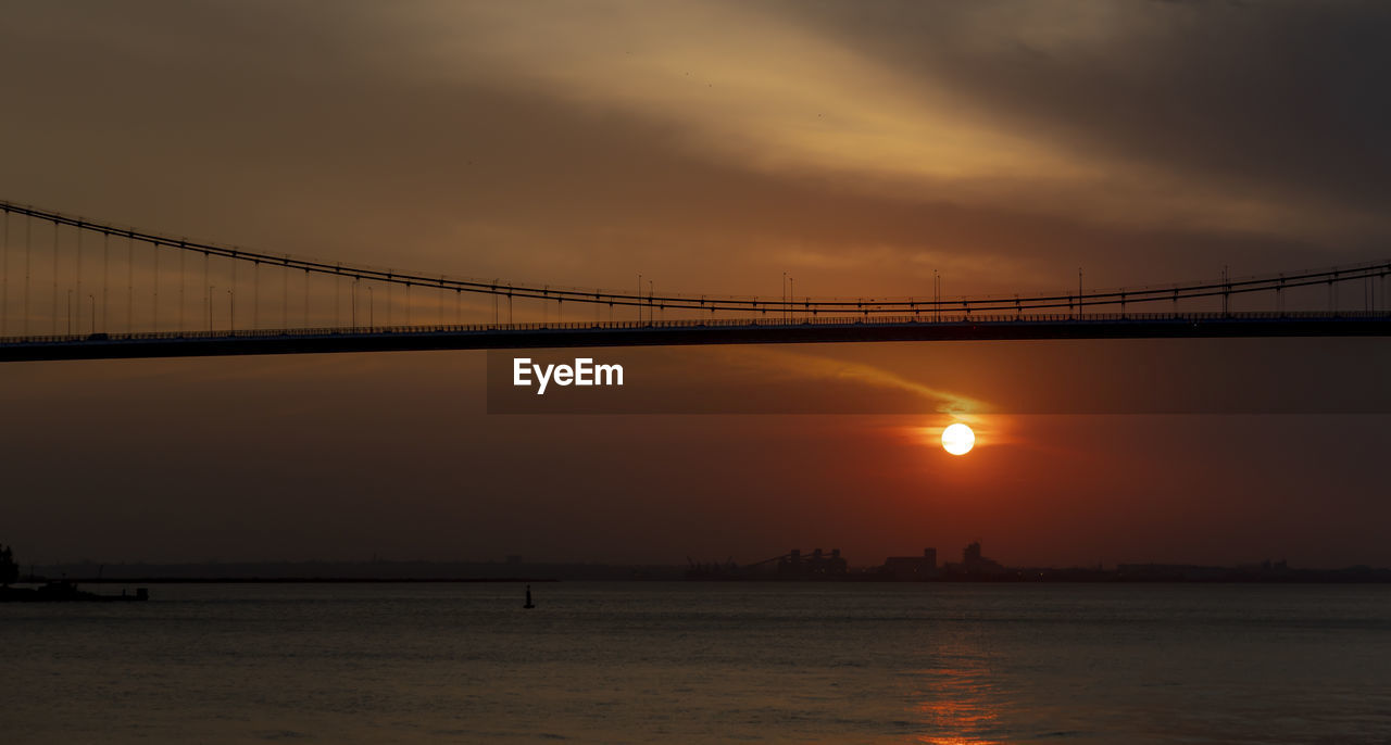 Scenic view of bridge against sky during sunset