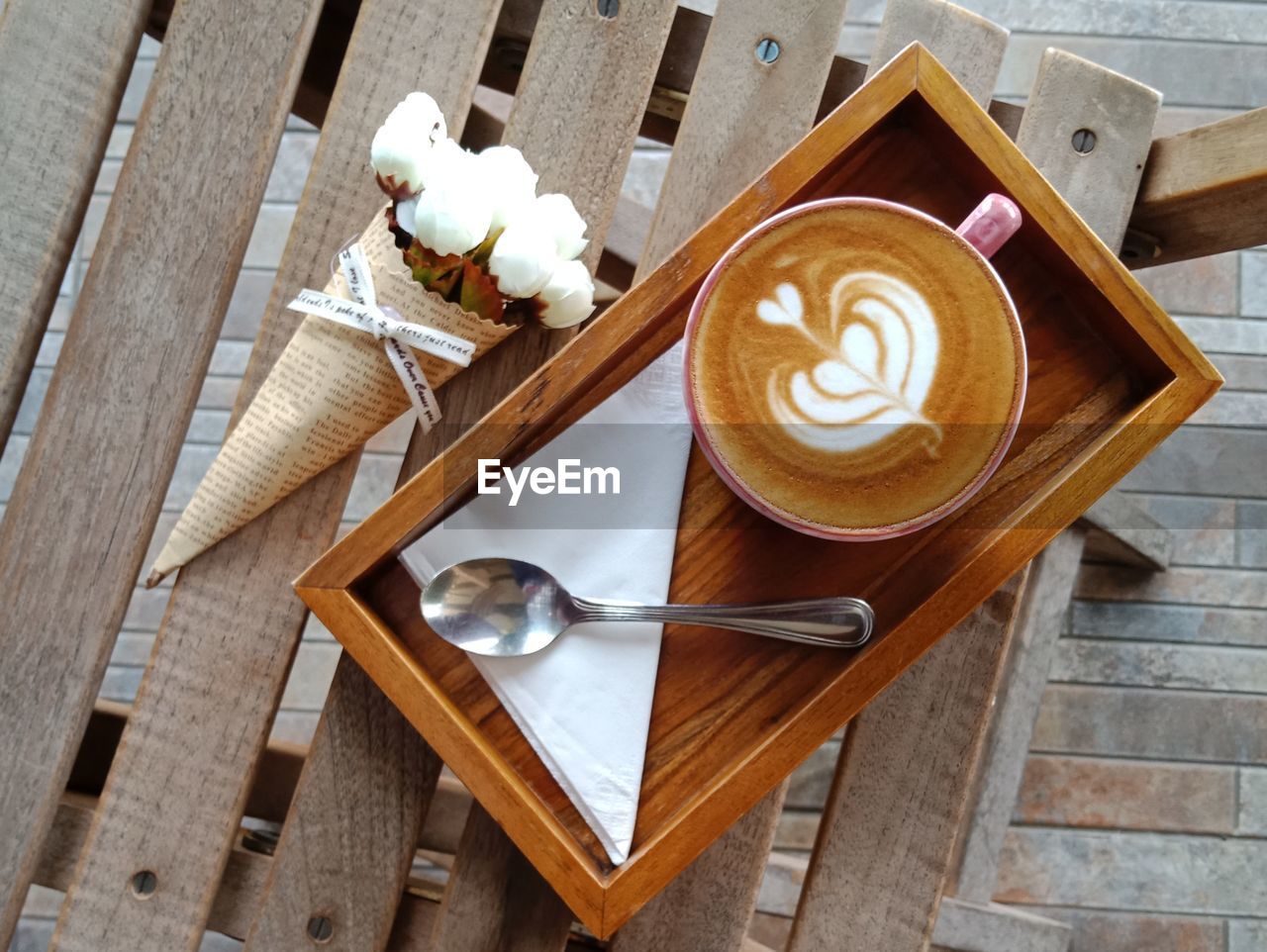 Coffee latte on a wooden tray