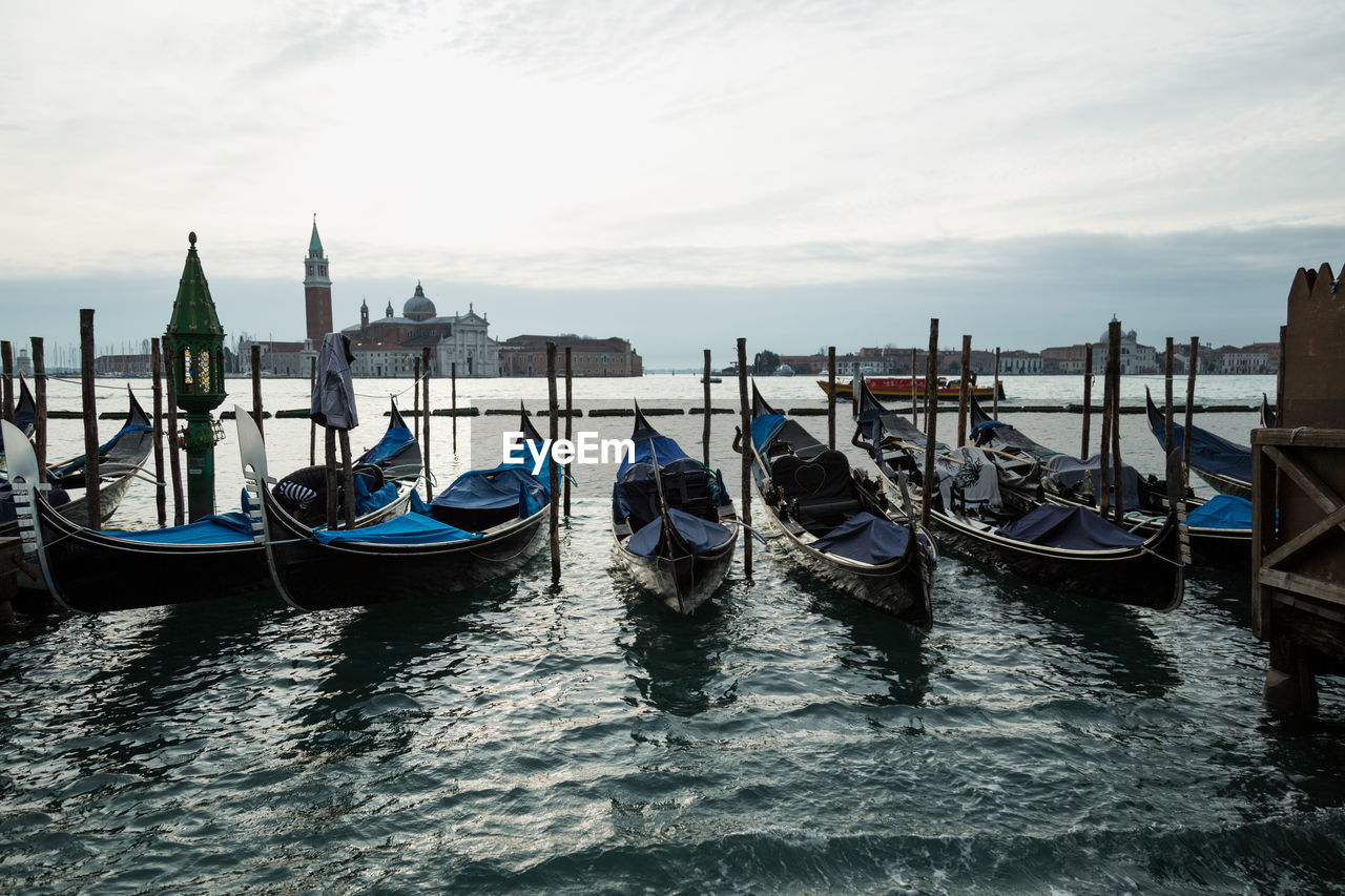 Gondolas moored on grand canal in city