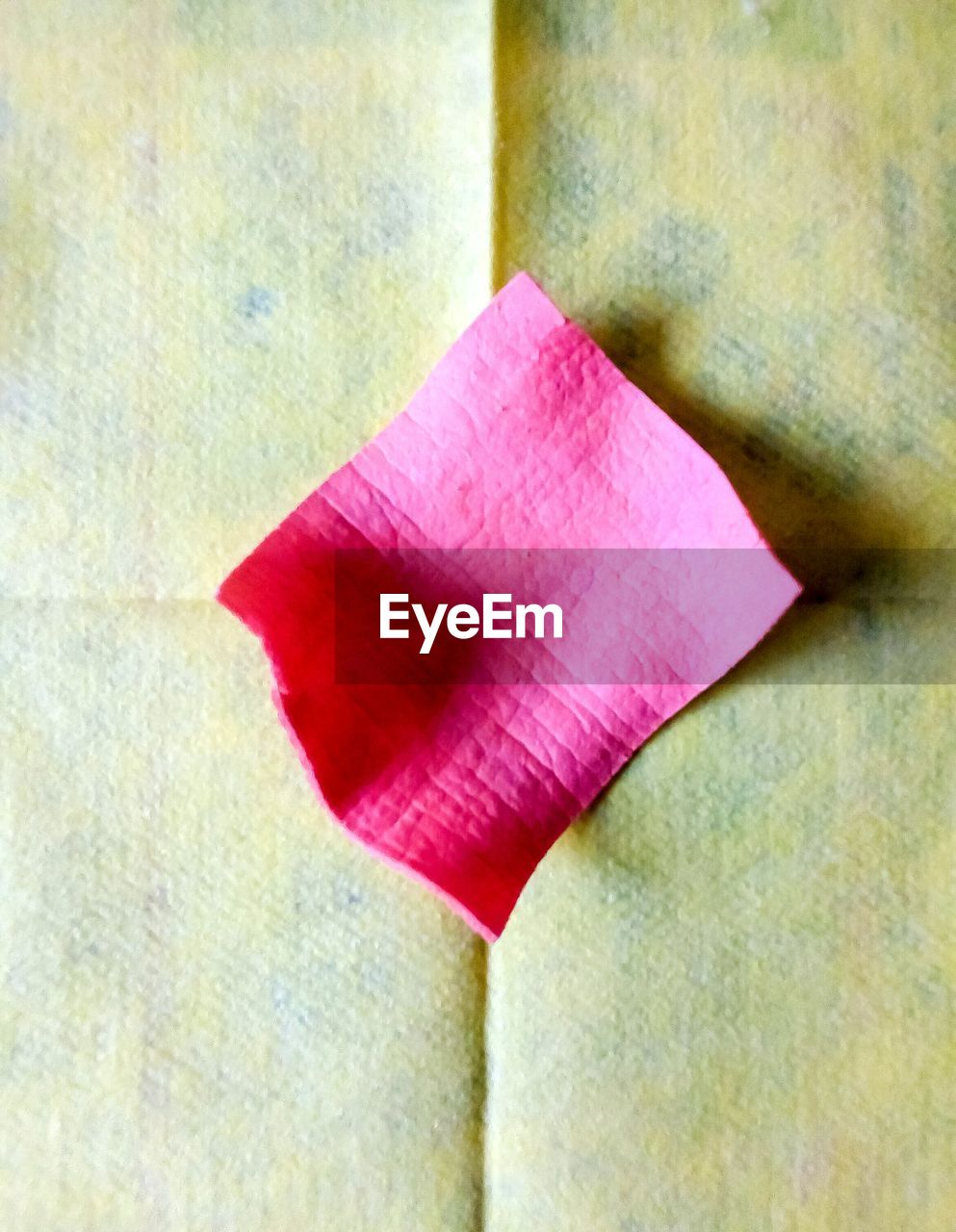 Close-up of pink adhesive note on board