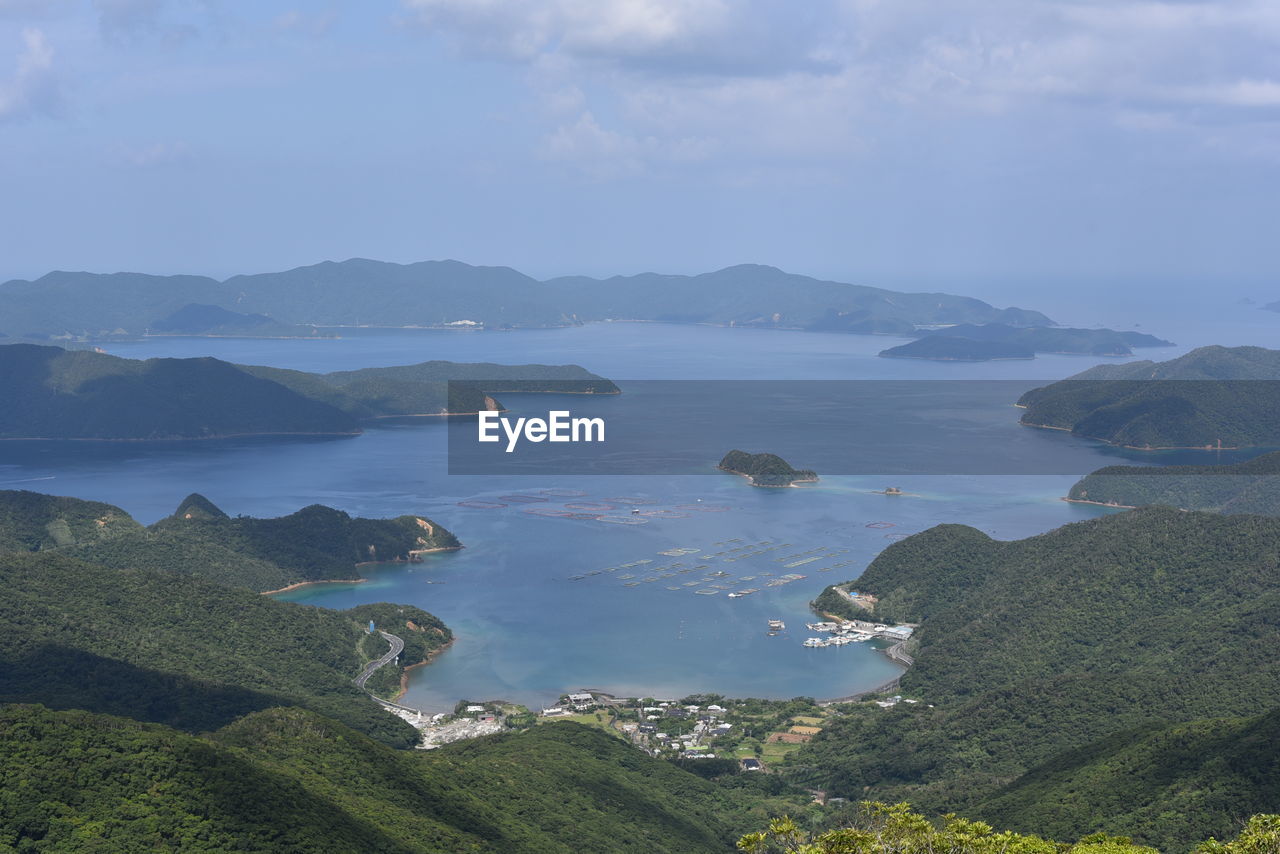 Scenic view of sea and mountains against sky