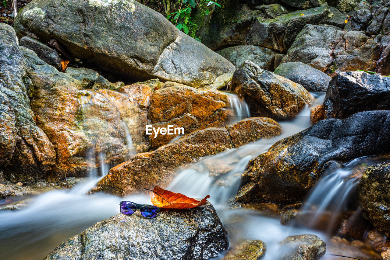 WATER FLOWING THROUGH ROCKS IN RIVER