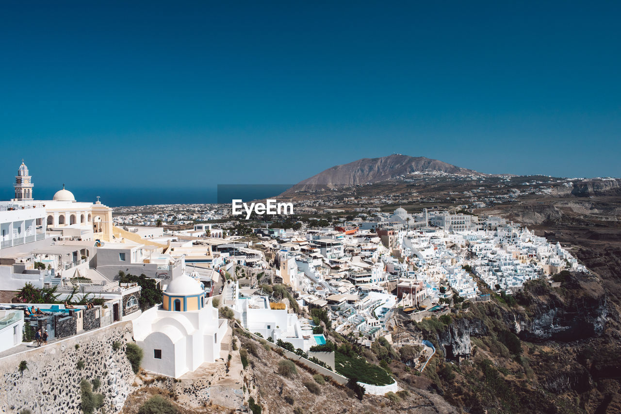 High angle view of townscape against clear blue sky