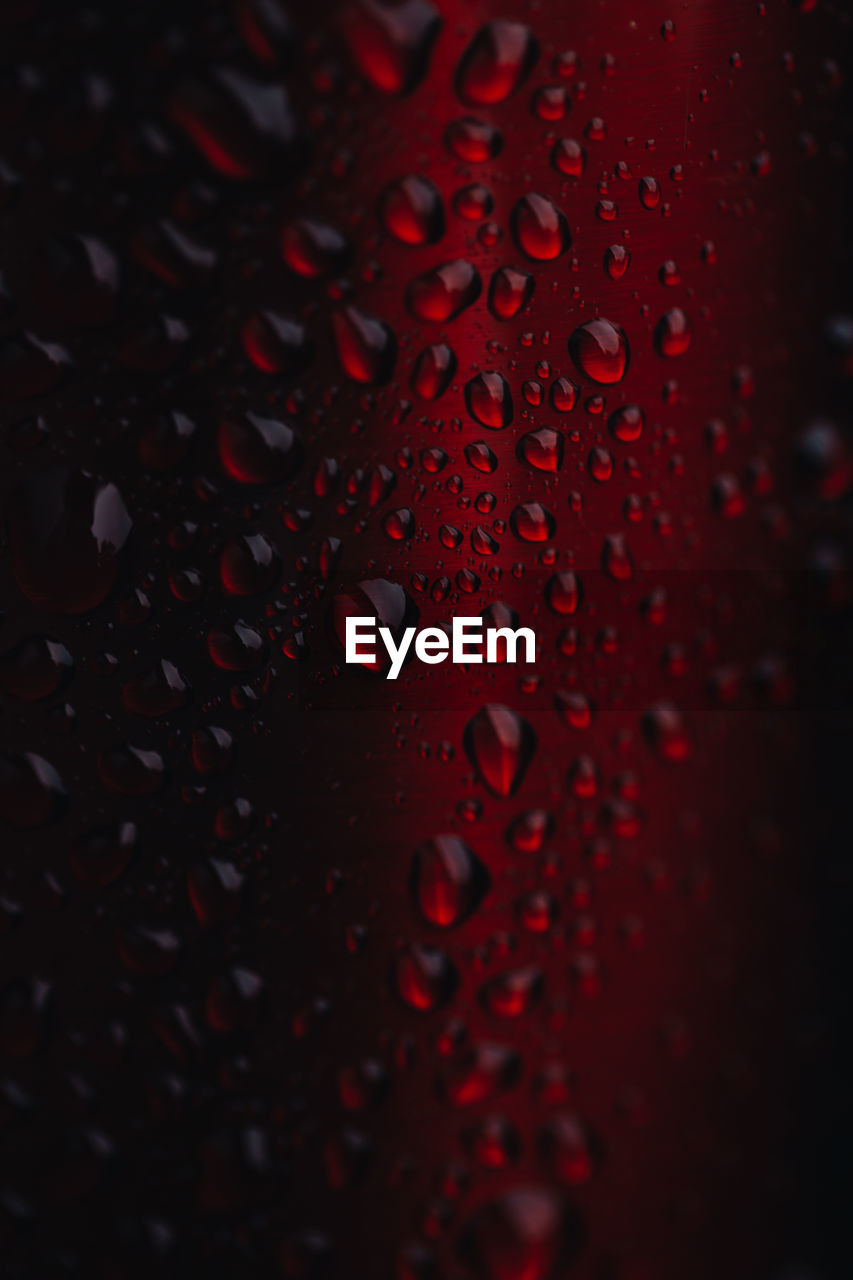 full frame shot of raindrops on glass