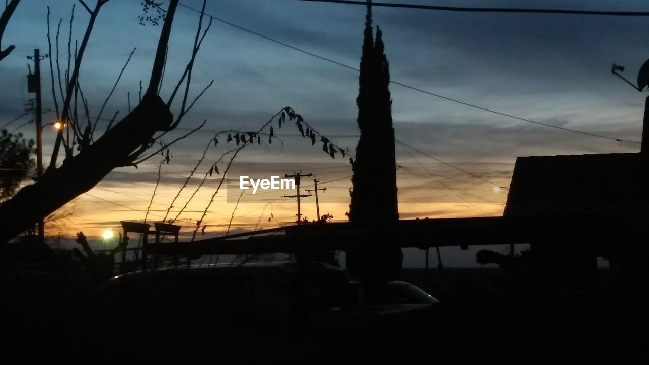 SILHOUETTE OF BRIDGE AGAINST SUNSET SKY