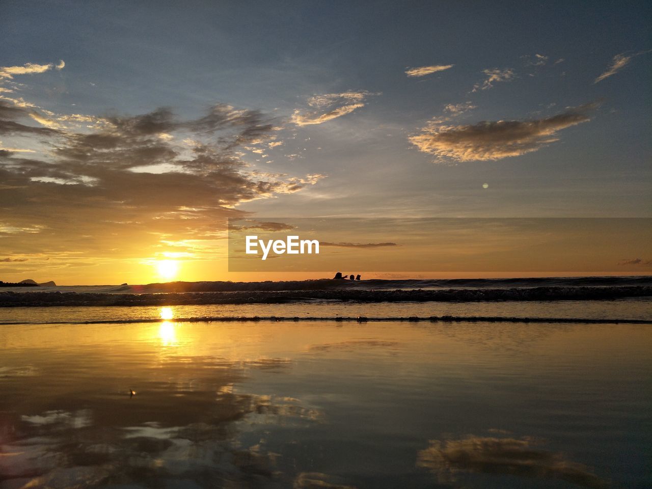 Scenic view of sea against sky at sunset