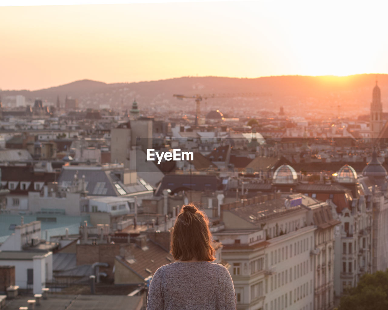 Rear view of woman looking at cityscape