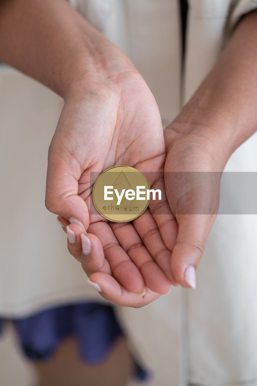 Unrecognizable black girl holding cryptocurrency with hands