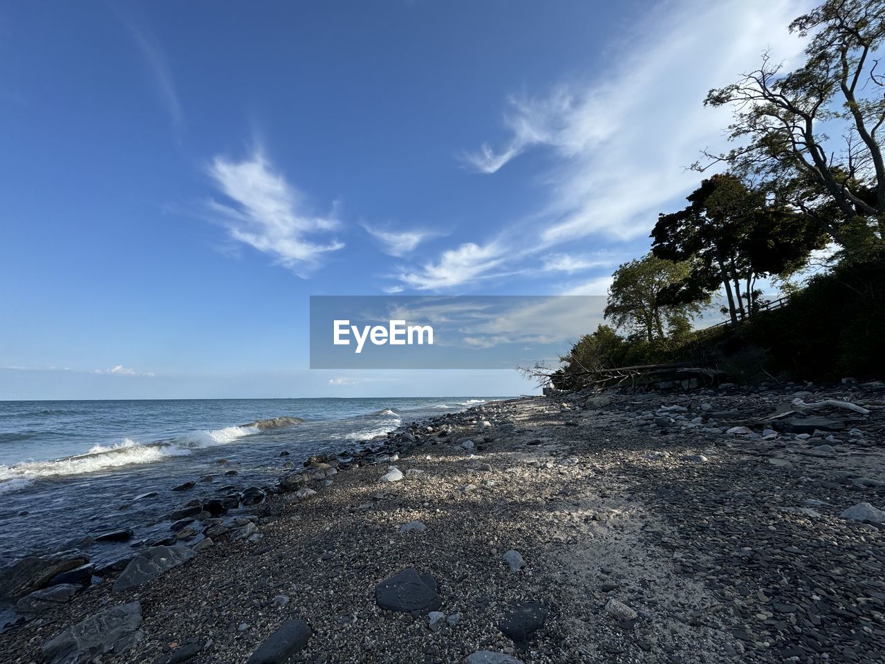 sea, sky, water, land, beach, shore, ocean, scenics - nature, body of water, coast, beauty in nature, horizon, nature, cloud, rock, wave, tree, sand, tranquility, horizon over water, coastline, tranquil scene, environment, no people, blue, travel destinations, plant, outdoors, sunlight, landscape, travel, day, idyllic, seascape, non-urban scene, wind wave, holiday, tourism, tropical climate, bay, cliff, motion, trip, vacation