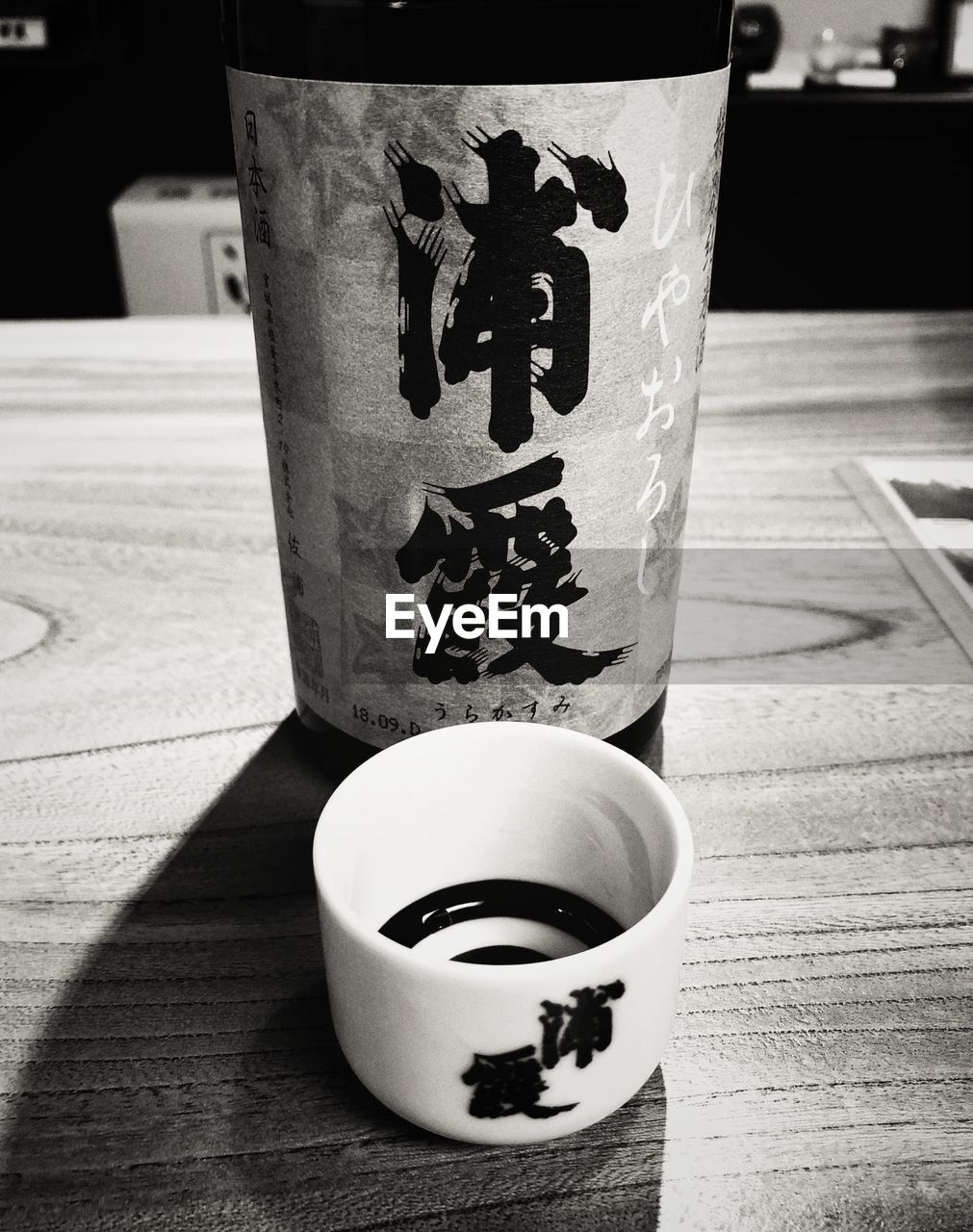 CLOSE-UP OF DRINK ON GLASS TABLE