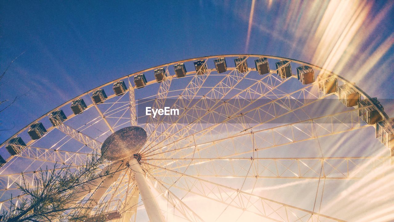 Low angle view of ferris wheel against sky