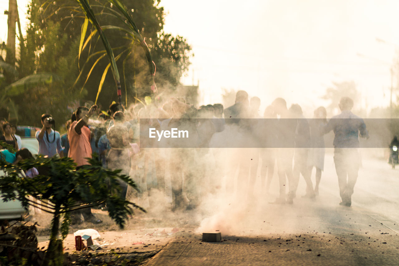 Group of people on street in city during traditional festival