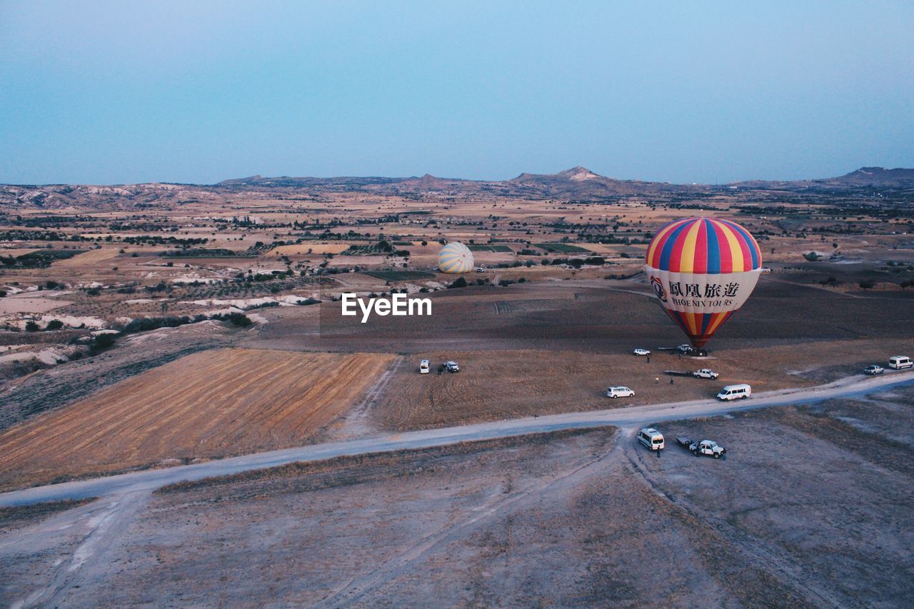 HOT AIR BALLOONS FLYING OVER LAND