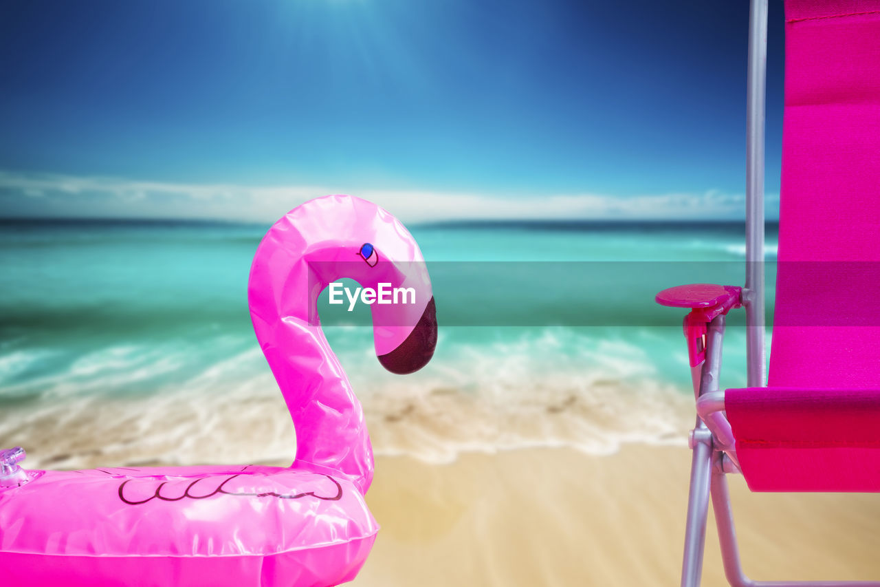 pink, sea, water, beach, land, bird, sky, nature, holiday, vacation, trip, sand, summer, horizon over water, no people, purple, outdoors, horizon, sunlight, travel, beauty in nature, blue, fun, day, inflatable, travel destinations